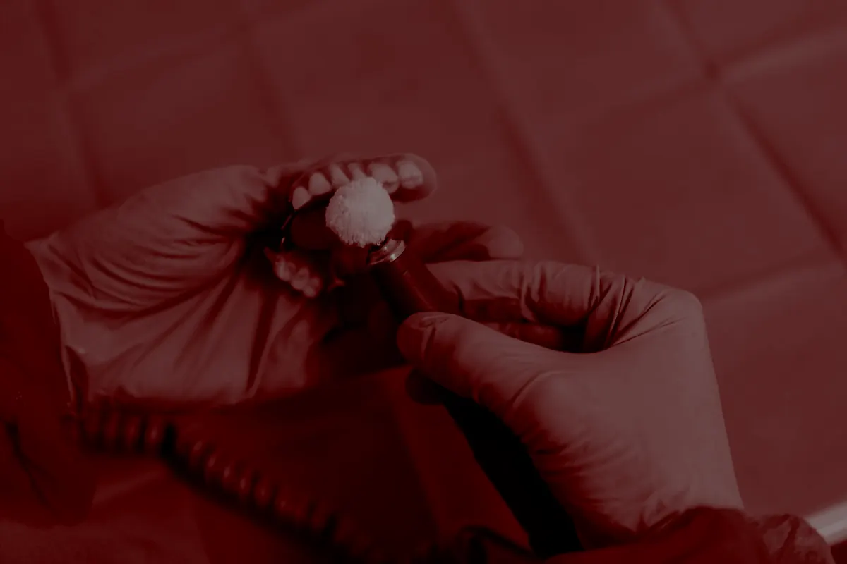 Dental technician working on a precision appliance under magnification