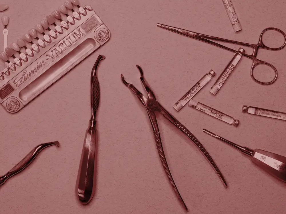 Dental instruments laid out beside a shade guide