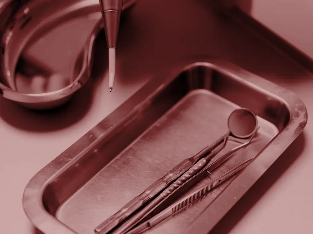Dental mirror and instruments on a steel tray