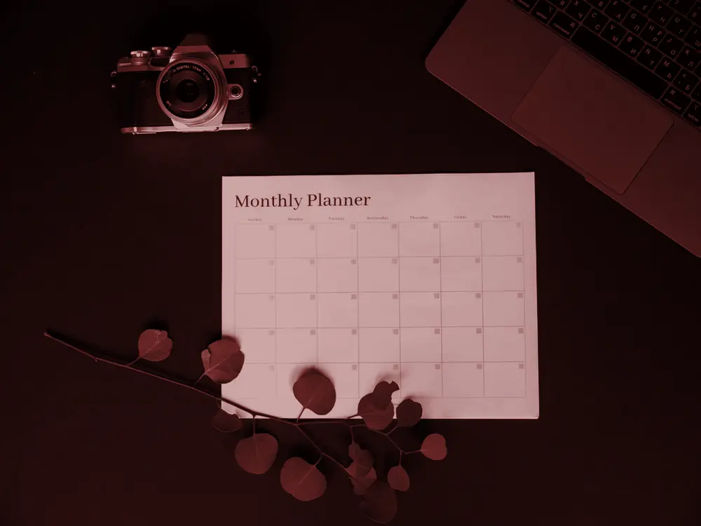 Monthly planner page on a dark desk