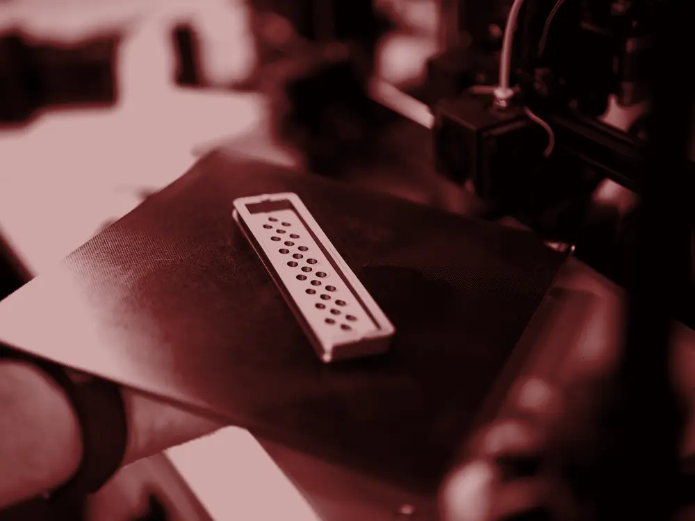3D printer building a model on its print bed