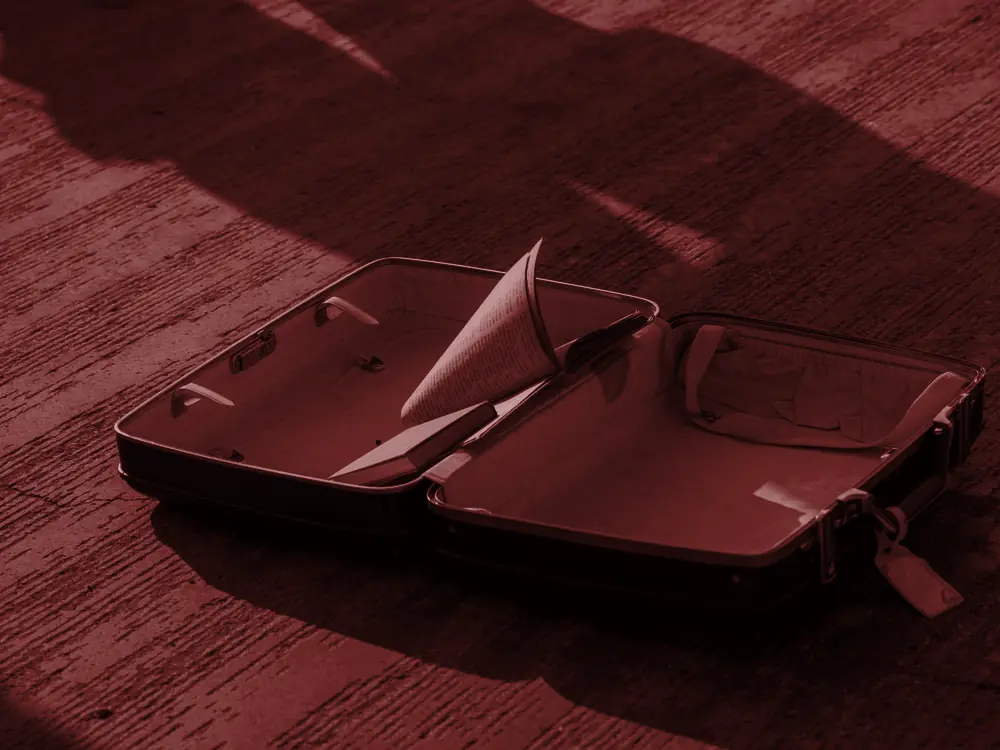 Open suitcase on the floor in sunlight