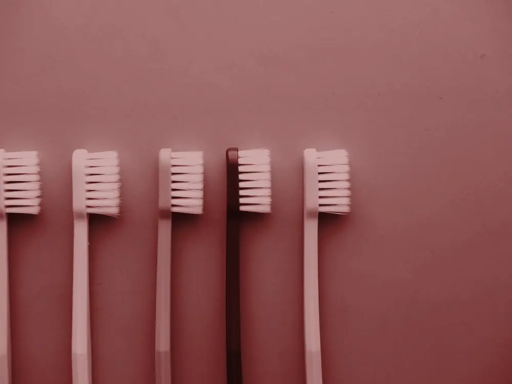 Toothbrushes laid out on a blue background