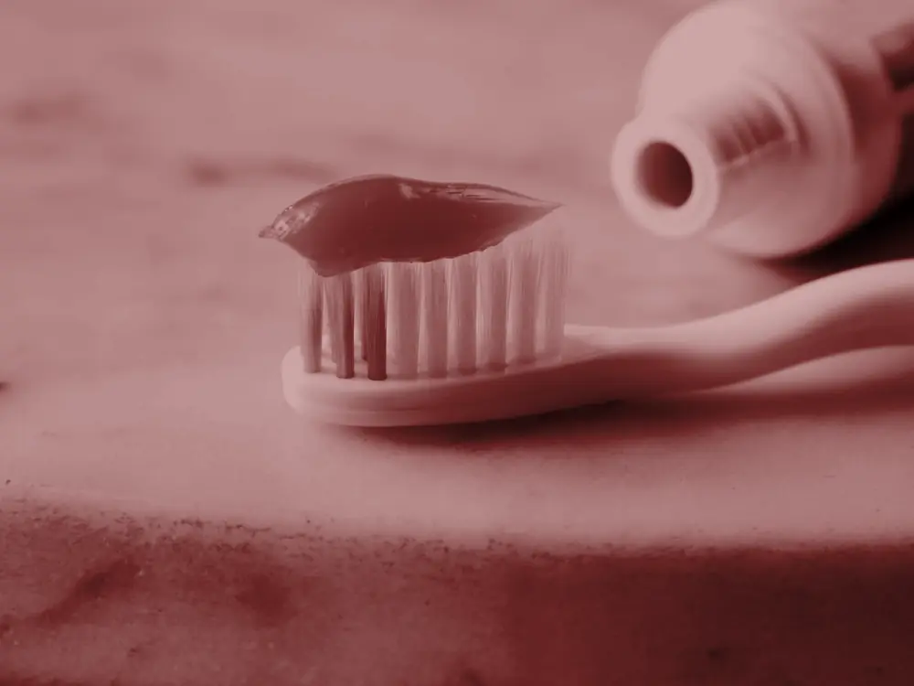 Toothbrush with toothpaste on a marble counter