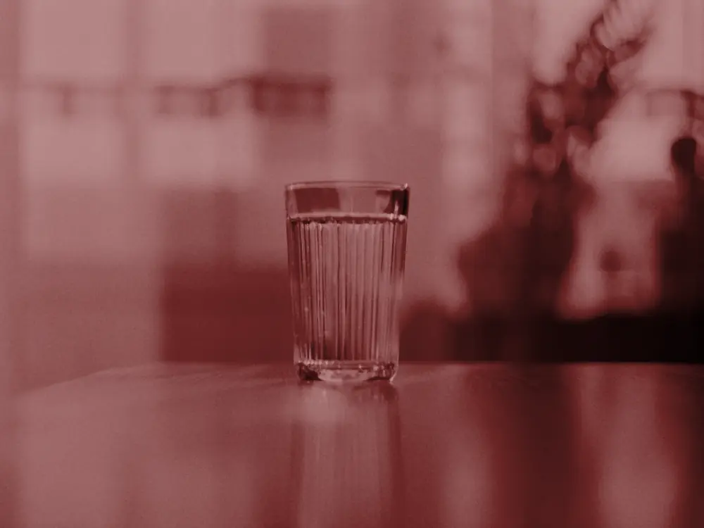 Glass of water on a table in soft daylight